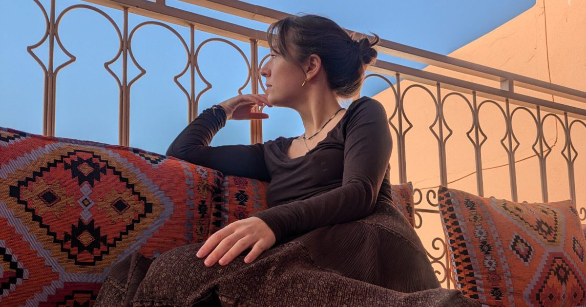 Title image What no one tells you about your first year freelancing / woman on a rooftop in Morocco